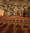 Red Ottoman Mosque Carpet angled view across the prayer hall